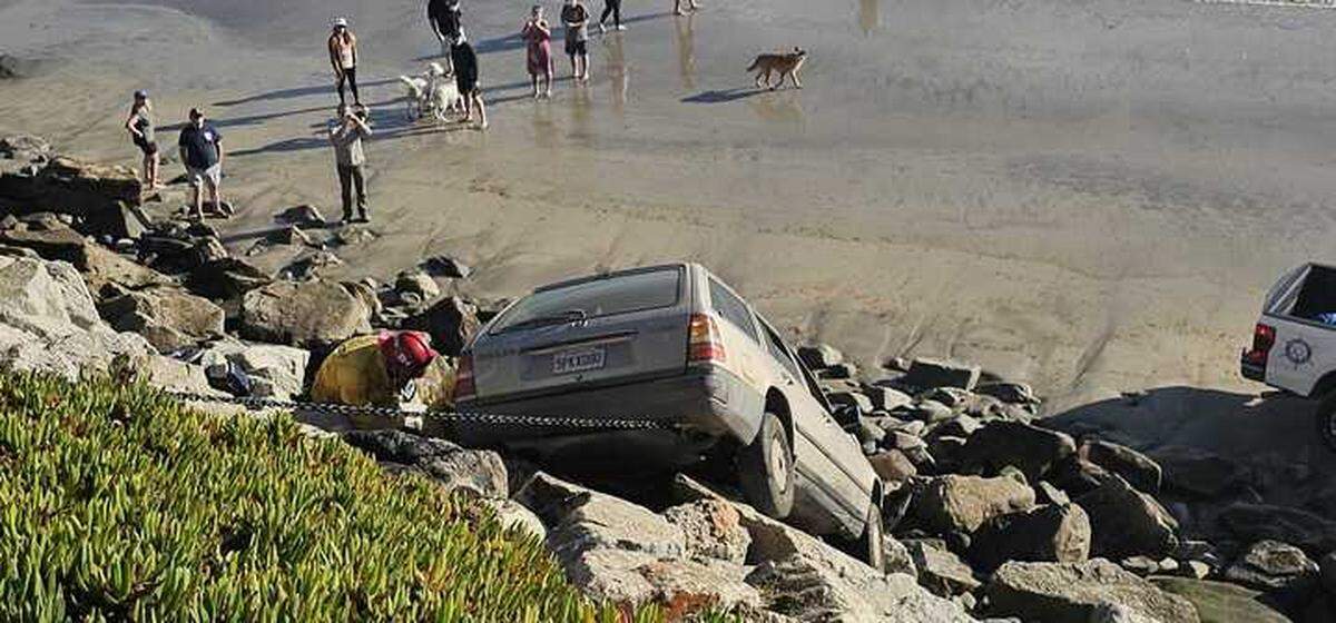 A car collided with another vehicle before crashing off of Avila Beach Drive onto Olde Port Beach below Wednesday, Jan. 1, 2025.