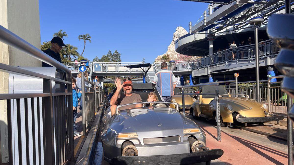 Aaron Lambert and daughter Casey take a spin around the Autopia track at Disneyland. The amusement park plans to retire the miniature, gas-powered cars and replace them with either electric vehicles or hybrids in the coming years.