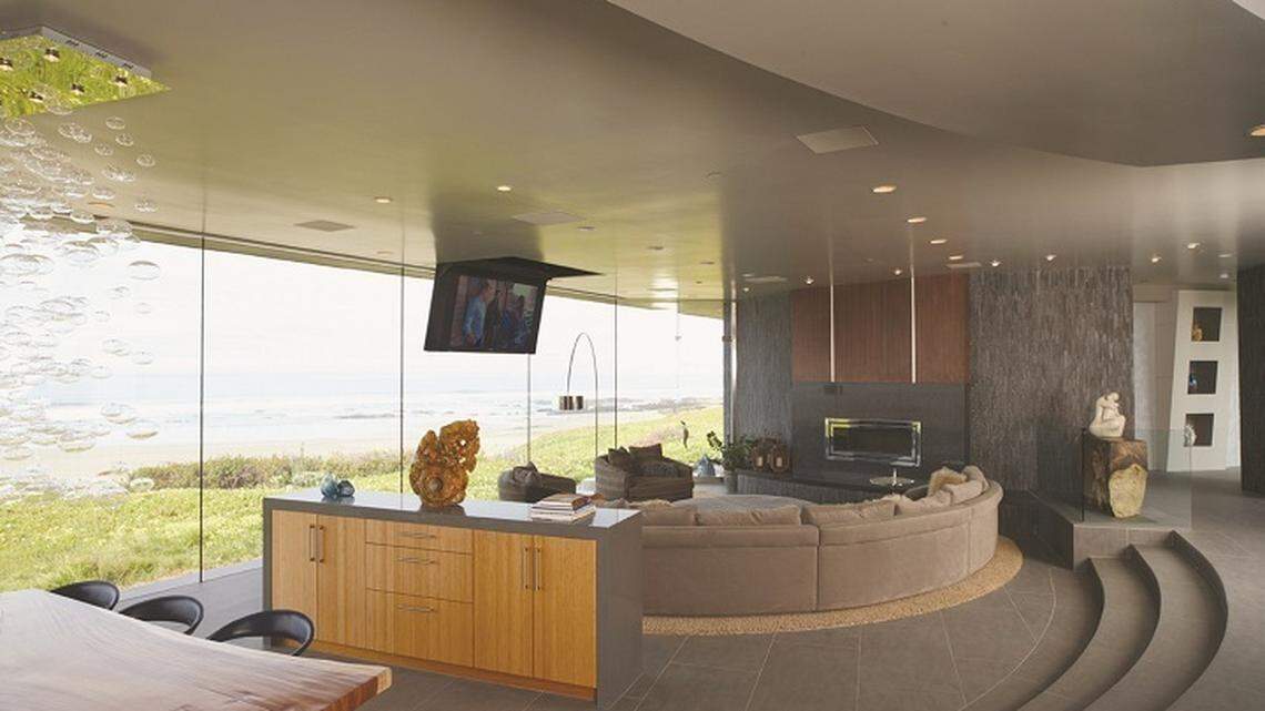 A repeated curve motif is embracing and soothing. The TV retracts out of sight to reduce visual clutter. More photos »