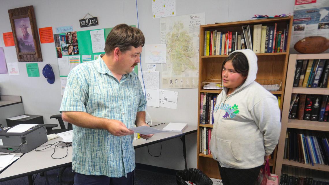 Shandon teacher Alan Sciocchetti talks to 6th grader Kaylen Sosa about a form that can be filled out from a homework packet but he is hoping will be filled out online. Homework packets are an interim step until students can get fast internet. David Middlecamp 4-23-2020