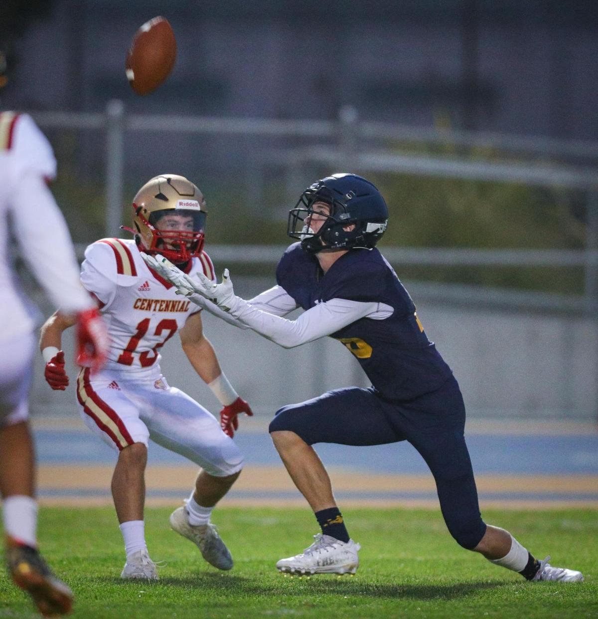 Koa Kopcho completes a fair catch next to Carson Eldridge in the Eagles’ 39-7 loss to Centennial of Bakersfield on Aug. 26, 2022.