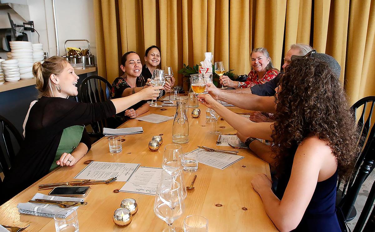 Keala Houston, left, and her sister Michelle Houston of San Luis Obispo make a toast with family and friends at Pair with Dead Oak in Atascadero. The brewery has added a food menu created by Chef Rachel Ponce.