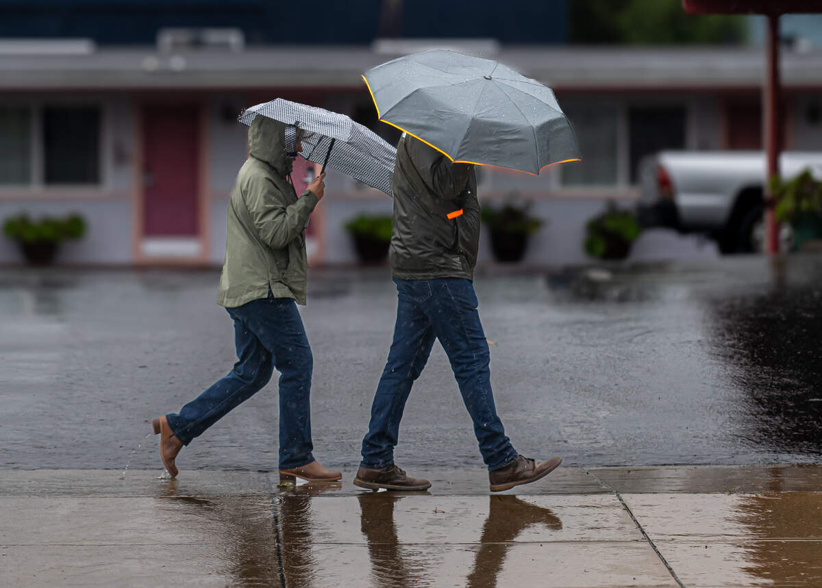 People walk around Morro Bay in the rain on Jan. 4, 2026.