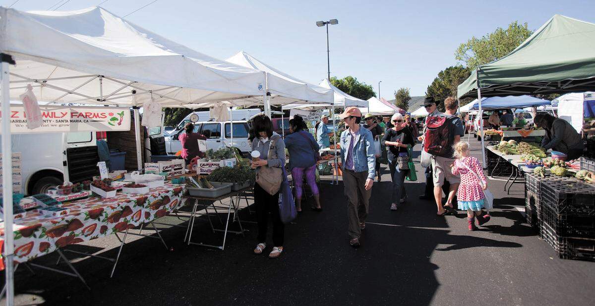 Shoppers peruse the produce at the Saturday morning farmers market held in the World Market parking lot in San Luis Obispo in 2015.