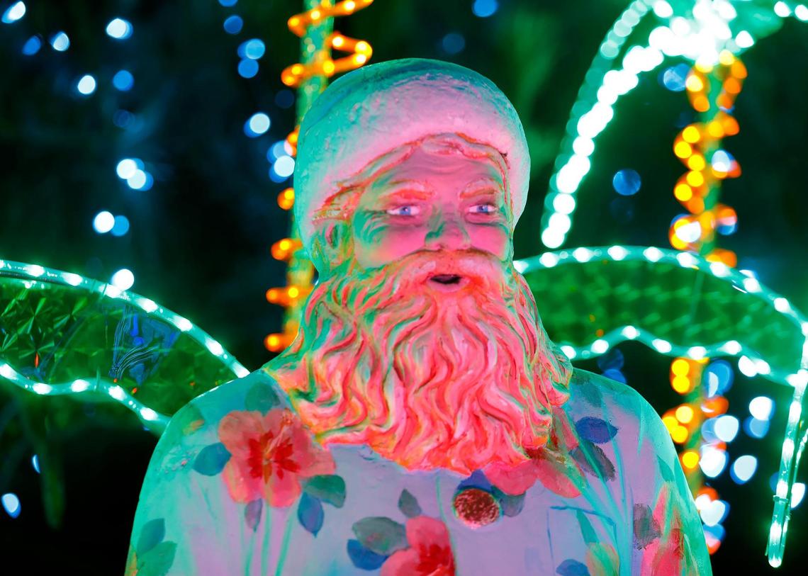 A surfing Santa Claus hangs loose at the Cambria Christmas Market on Wednesday, Dec. 14, 2022.