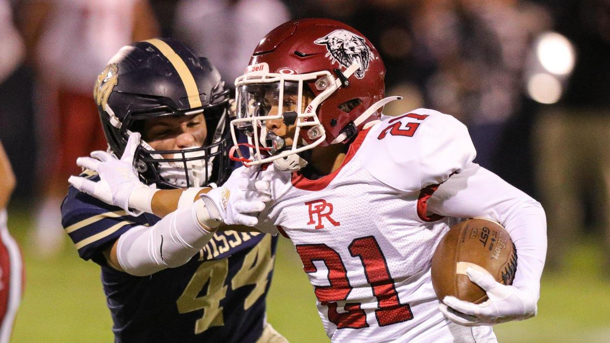 Ashton Murphy straight arms Conner Lopez. Mission Prep defeated Paso Robles 28-7 in a Mountain League football game on Sept. 30, 2022, in San Luis Obispo.