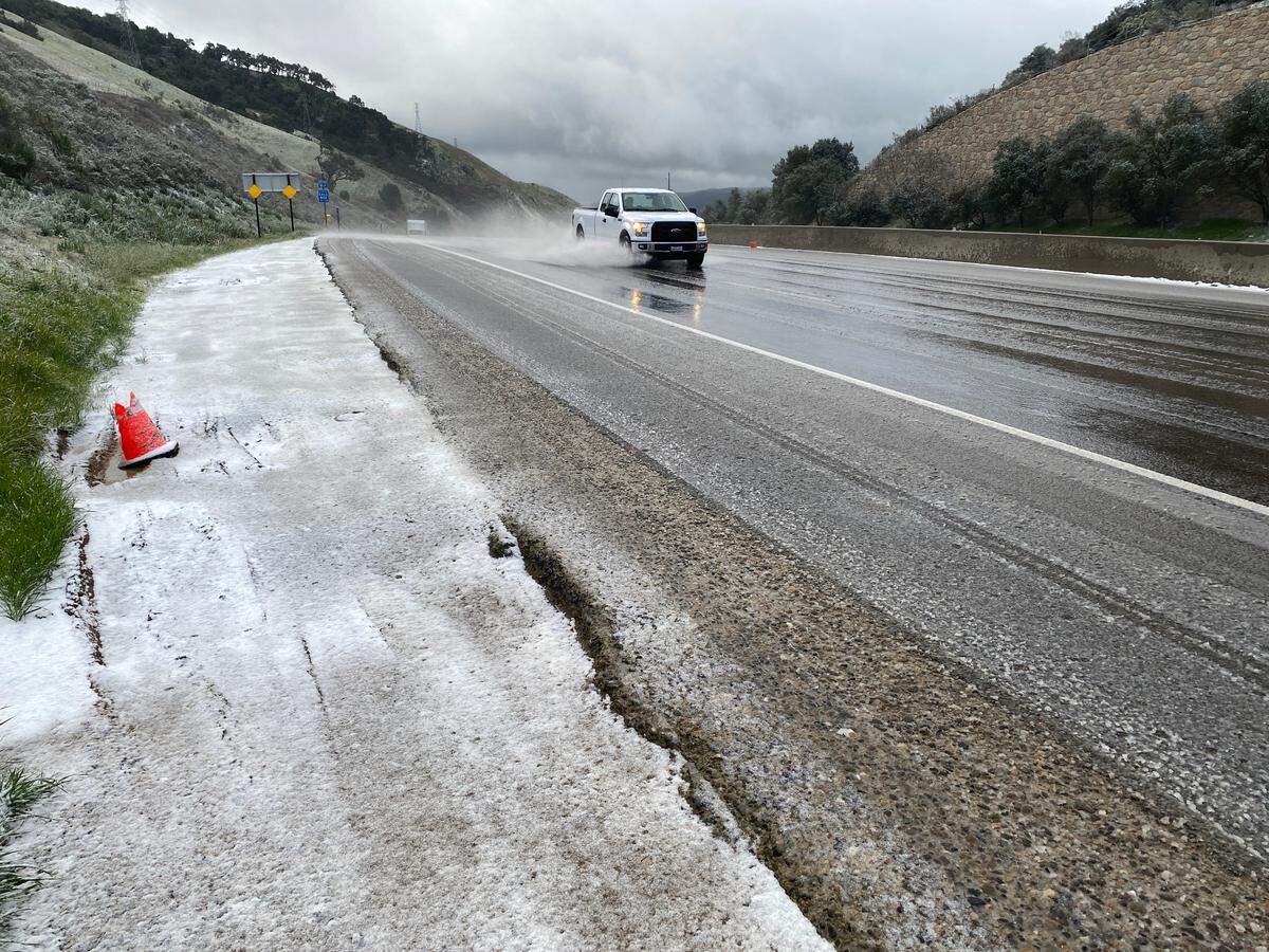 Slush coats the side of Highway 101 on the Cuesta Grade on Thursday, Feb. 23, 2023.