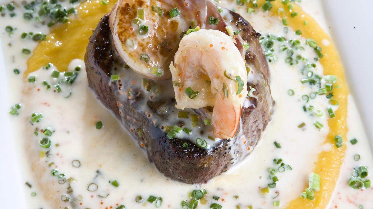 The Surf and Turf at Hoppe's in Cayucos features a filet mignon with a prawn and prosciutto-wrapped scallop on a butternut squash puree.