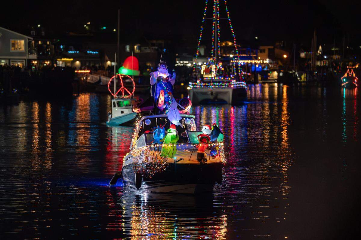 Boats equipped with festive lighting make their way into Morro Bay Harbor on Saturday, Dec. 13, 2025. The parade drew thousands of onlookers and dozens of boats equipped with festive lighting.