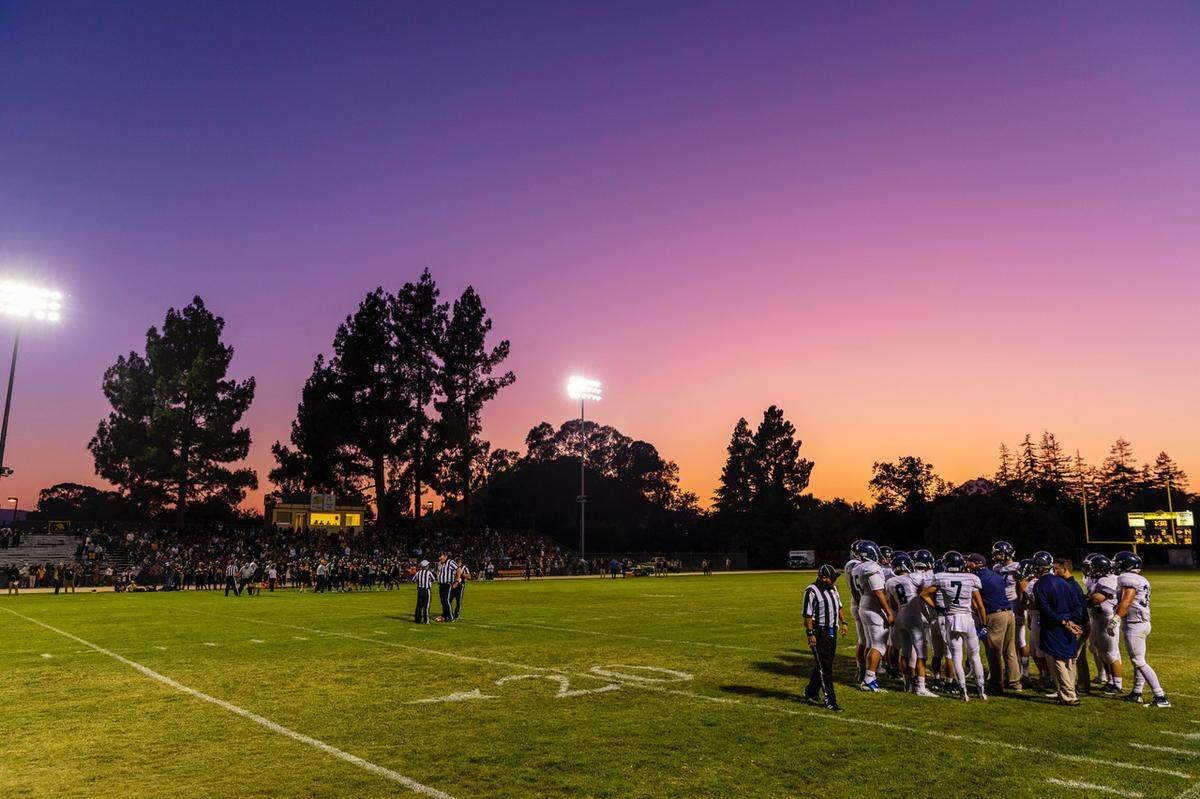 A spectacular sunset provides the backdrop to Friday night’s football game between host San Luis Obispo and Arroyo Grande high schools.
