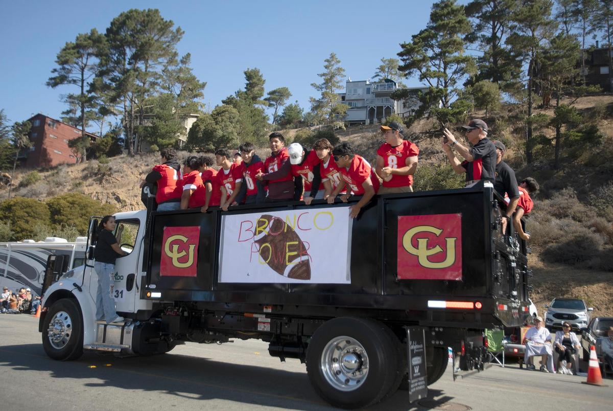 The Coast Union Football team shouts “Bronco power” while participating in the Pinedorado Parade in Cambria on Saturday, Sept. 3, 2022.