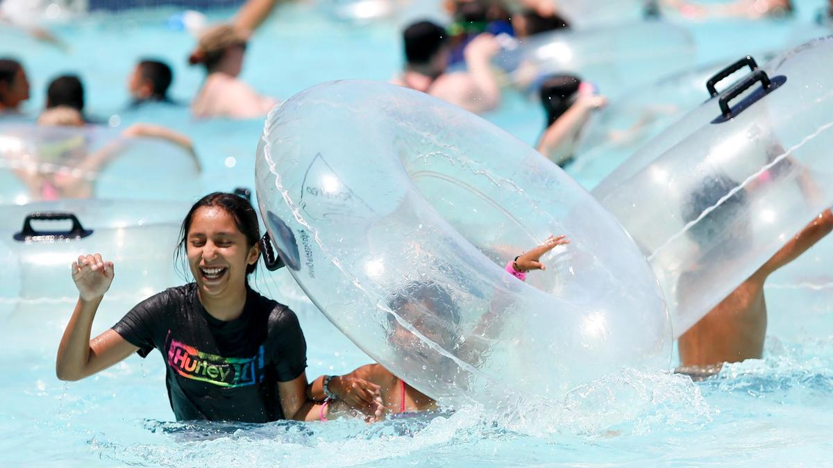 Kids play in the Calypso Bay Wave Pool at The Ravine Water Park in Paso Robles as temperatures hit the triple-digits on Thursday, July 27, 2023.