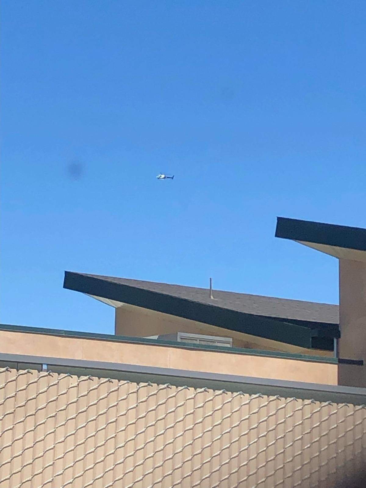 A helicopter flies over Atascadero High School on Wednesday, Aug. 31, 2022. The school was placed on lockdown and students were sheltering in place.
