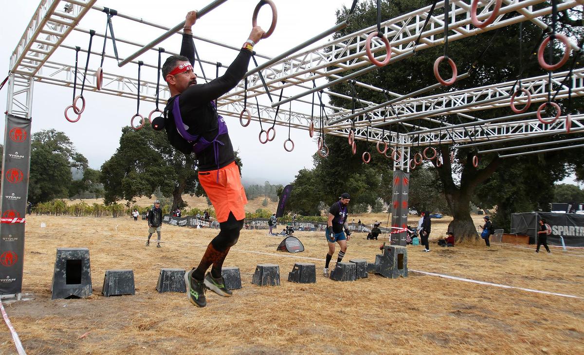 A participant tackles the multi-rig swing during the Spartan race event held in Santa Margarita on Saturday, Nov. 2, 2024, featuring a variety of obstacles and courses of different challenge levels.