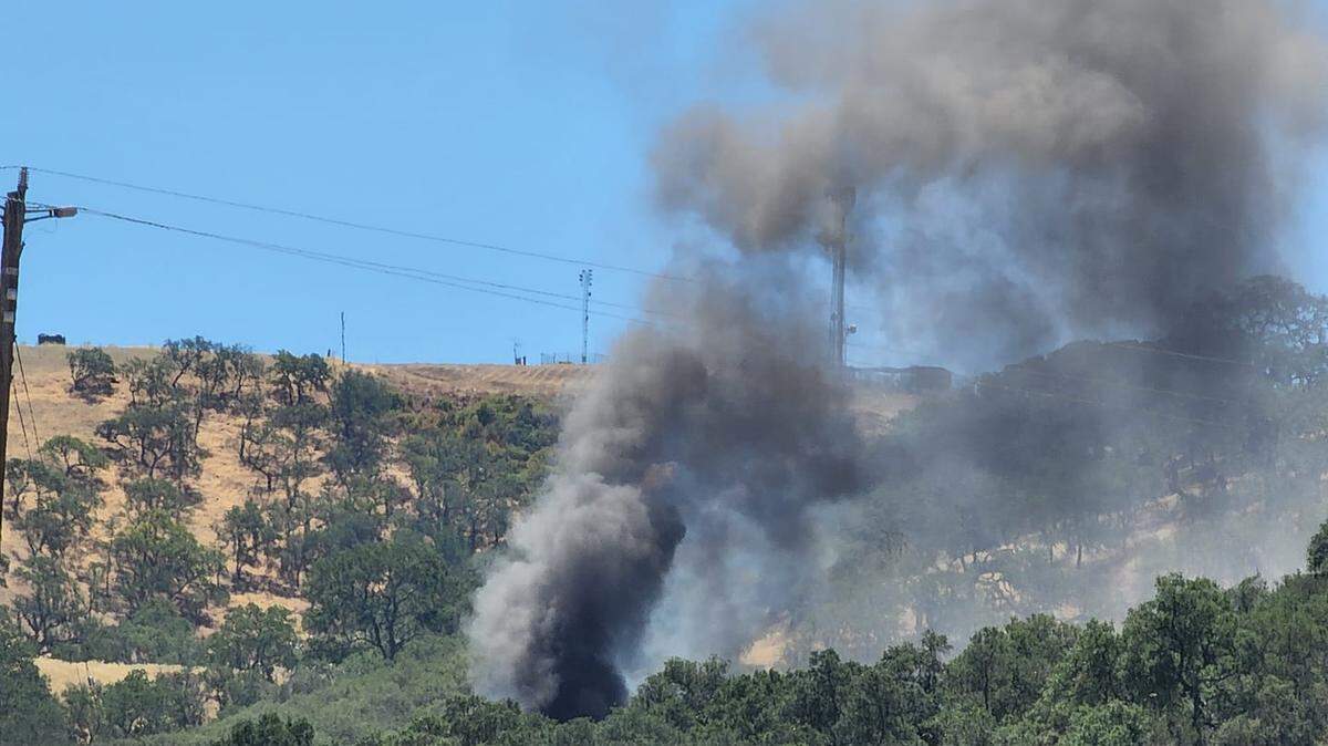 Smoke pours from a house that caught fire off of Highway 41 near Atascadero on Wednesday, June 15, 2022.