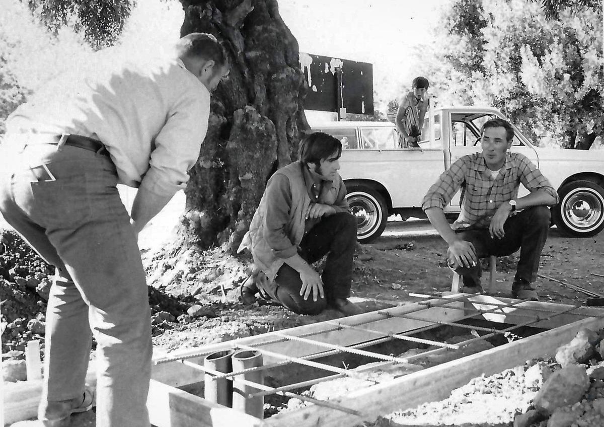 Will Hairgrove, left, Edward Perry and John Rebensdorf complete the framework for a portion of the electrical system for lighting at Frank Holt Field. Published on Sept. 4, 1971.