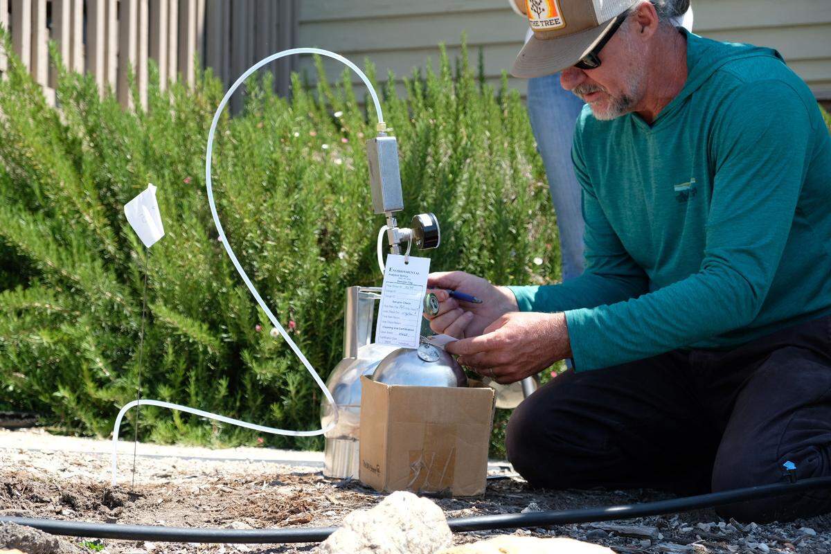 Tim Nelligan tests the soil in the front yard of the house next door to Susan Flores’ home in Arroyo Grande on Thursday, May 7, 2026, during the second day of a search warrant investigation in the Kristin Smart murder case.