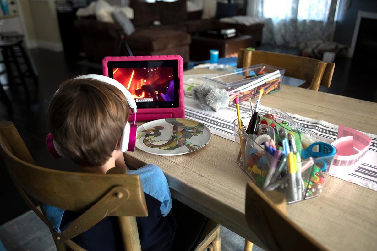 Tracy Dauterman and her sons eat snacks after school and relax at home. Dauterman of Paso Robles vaccinated both Colton, 7, and Brady, 5, for COVID-19 shortly after it was approved for use in kids aged 5 to 11.