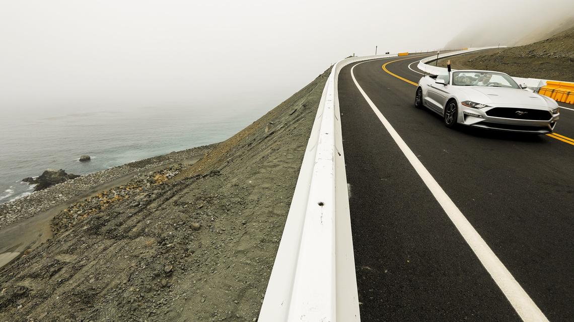 The first cars drive along the newly opened section of Hwy. 1 across the Mud Creek Slide earlier this year. Highway 1 will likely be closed at both Mud Creek and Paul’s Slide as a storm with heavy rain approaches.