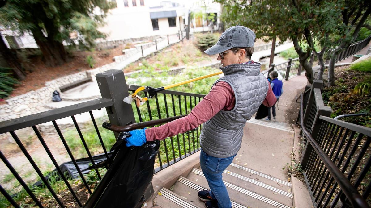 Dede Janzen and Dorothy McLean (background), both of San Luis Obispo, team up to clean areas around San Luis Creek on Sept. 17, 2022.