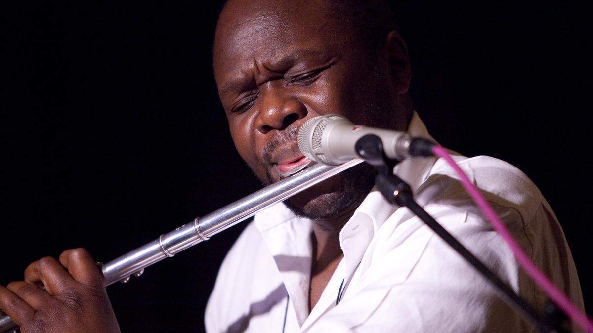 Samite, performing in San Luis Obispo, plays a flute.