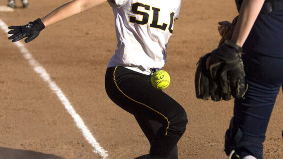 San Luis Obispo High’s Hailey Rich scores on a wild pitch in the Tigers’ 
26-0 win over Mission Prep on Friday. The Royals’ Emily Capps is at right.