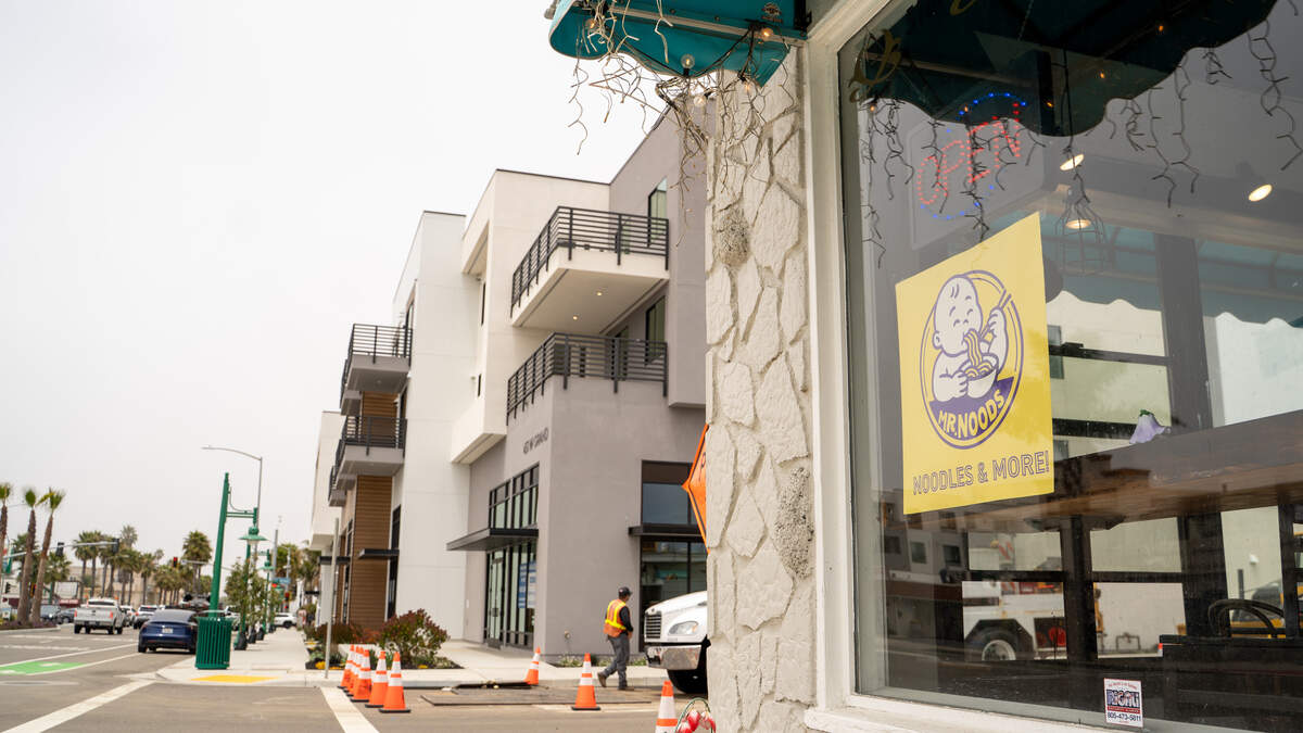 The storefront of Mr. Noods is overshadowed by the Encore development by Coastal Community Builders on West Grand Avenue in Grover Beach on June 12, 2026. The business is facing relocation as its lot is redeveloped into another multi-story, mixed-use building.