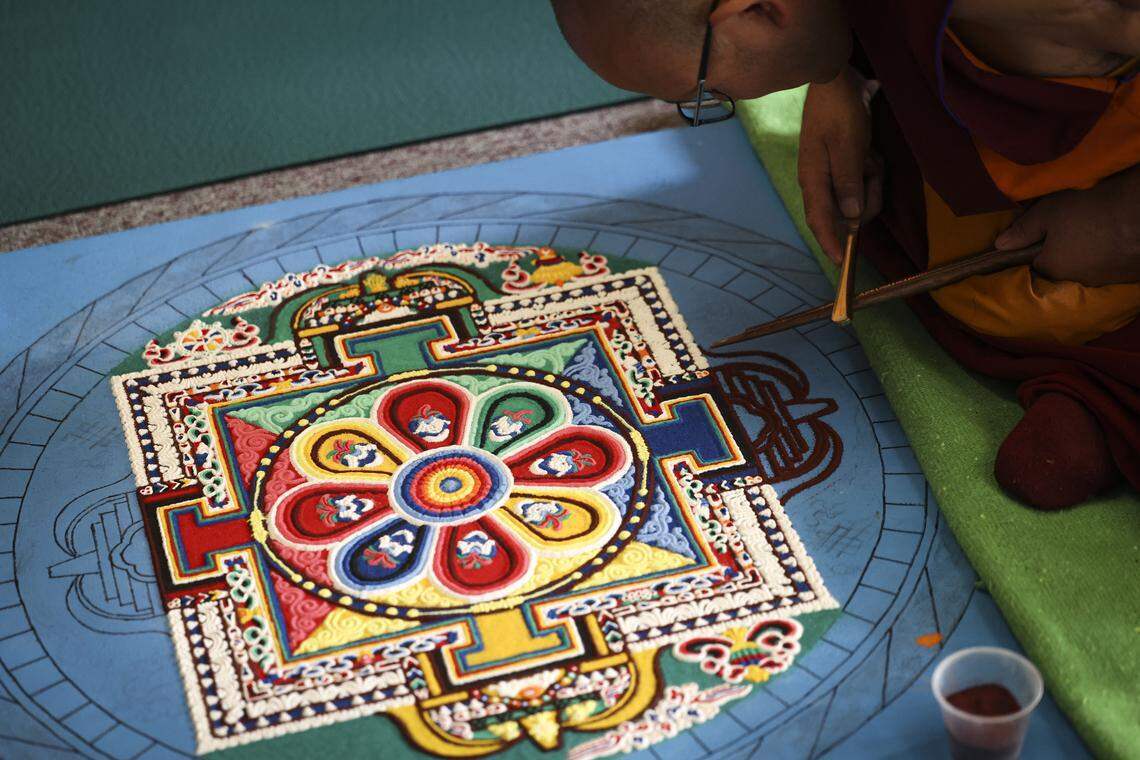 Ven. Rigzin uses a tool to distribute sand. Buddhist monks from Tibet were in Atascadero creating a Medicine Buddah Sand Mandala, with the intention to distribute healing energy to all sentient beings and eliminate suffering on Oct. 23, 2025.