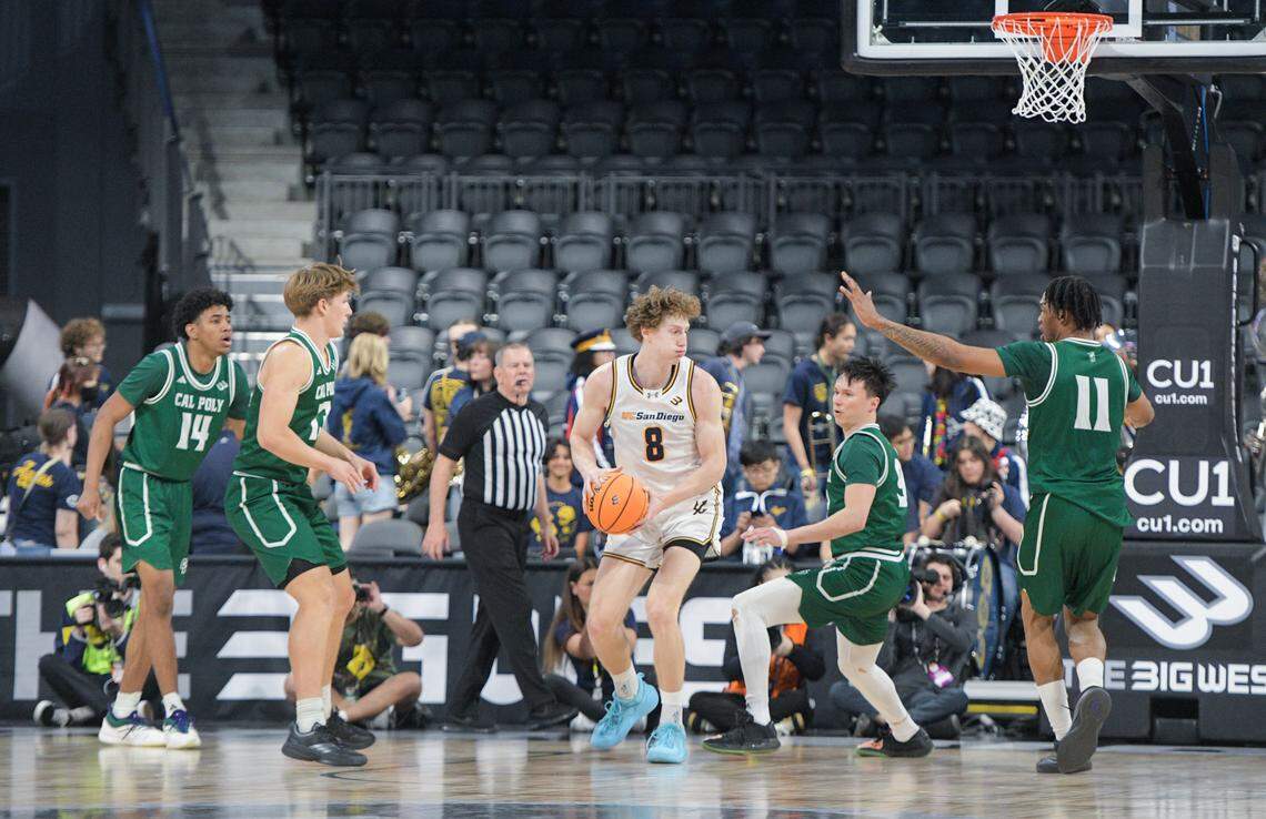 UC San Diego’s Leo Beath works in the post while guarded by Cal Poly’s Peter Bandelj and Austin Goode during the first round of the Big West Championships on March 12, 2026. The Mustangs fell 72-69 to the Tritons in Henderson, Nevada.