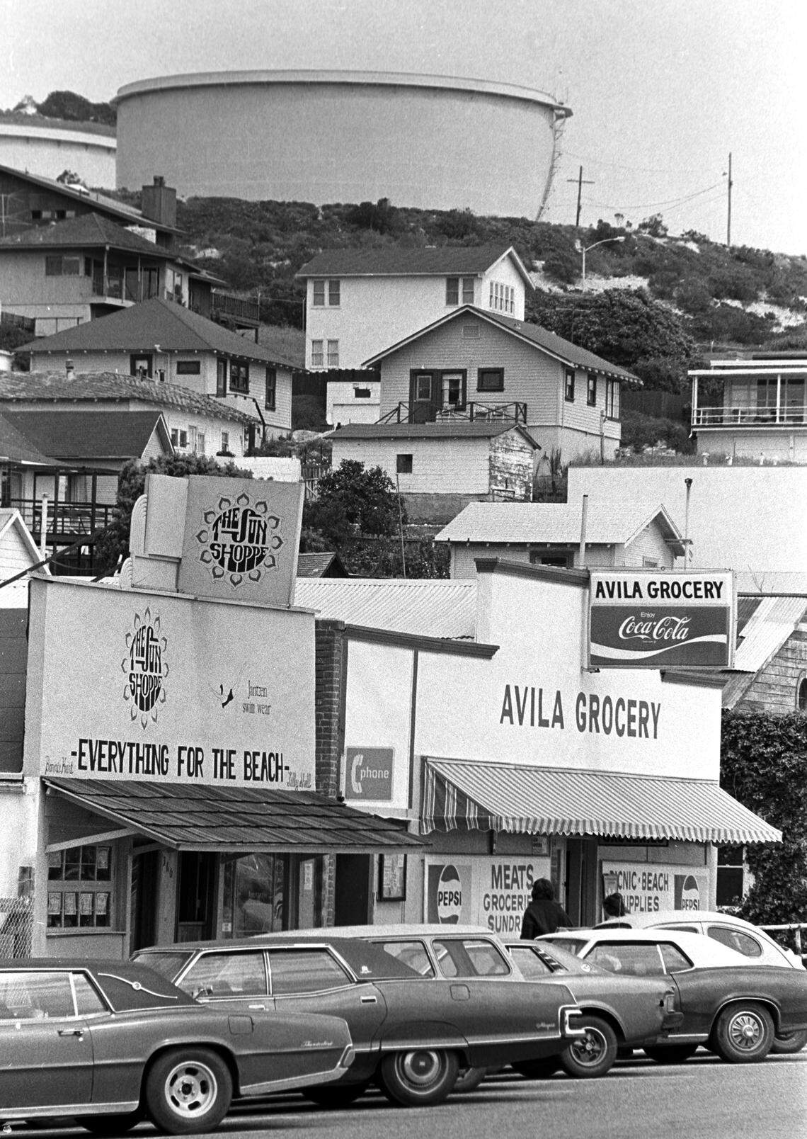 Small shops and hillside homes grace Avila Beach, as Union Oil tanks loom above April 5, 1978. Residents are wary about proposed LNG terminal site.