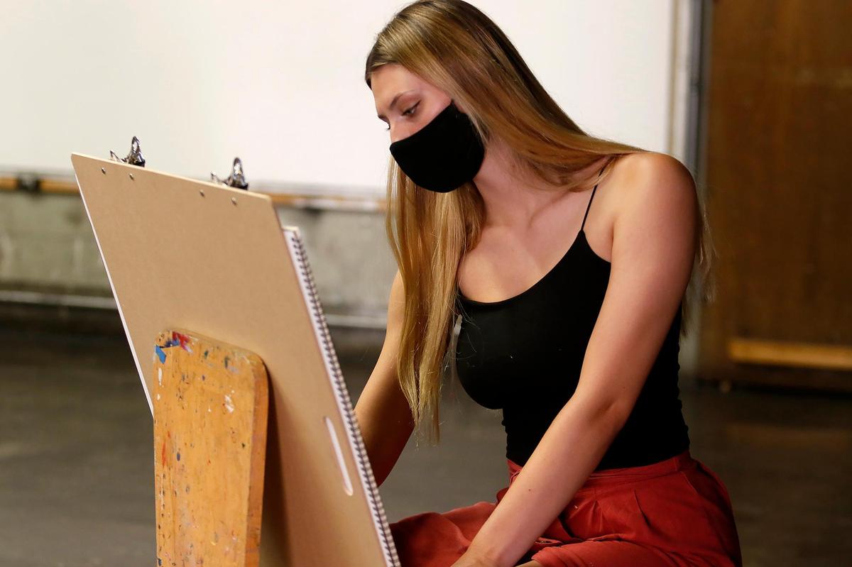 Cuesta College holds its first day of class for beginning art during the coronavirus pandemic. Allison Hambly draws in David Prochakas’ art class while wearing a mask and practices social distancing.