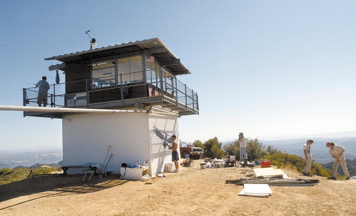The lookout has spectacular views from its 3180 foot elevation in the Santa Lucia range. It is over 6 miles of dirt road south of Pozo so visitors are advised to check the website www.condorlookout.org Anthony Prieto paints a life size condor mural on the side of the former fire lookout Oct. 6, 2002.