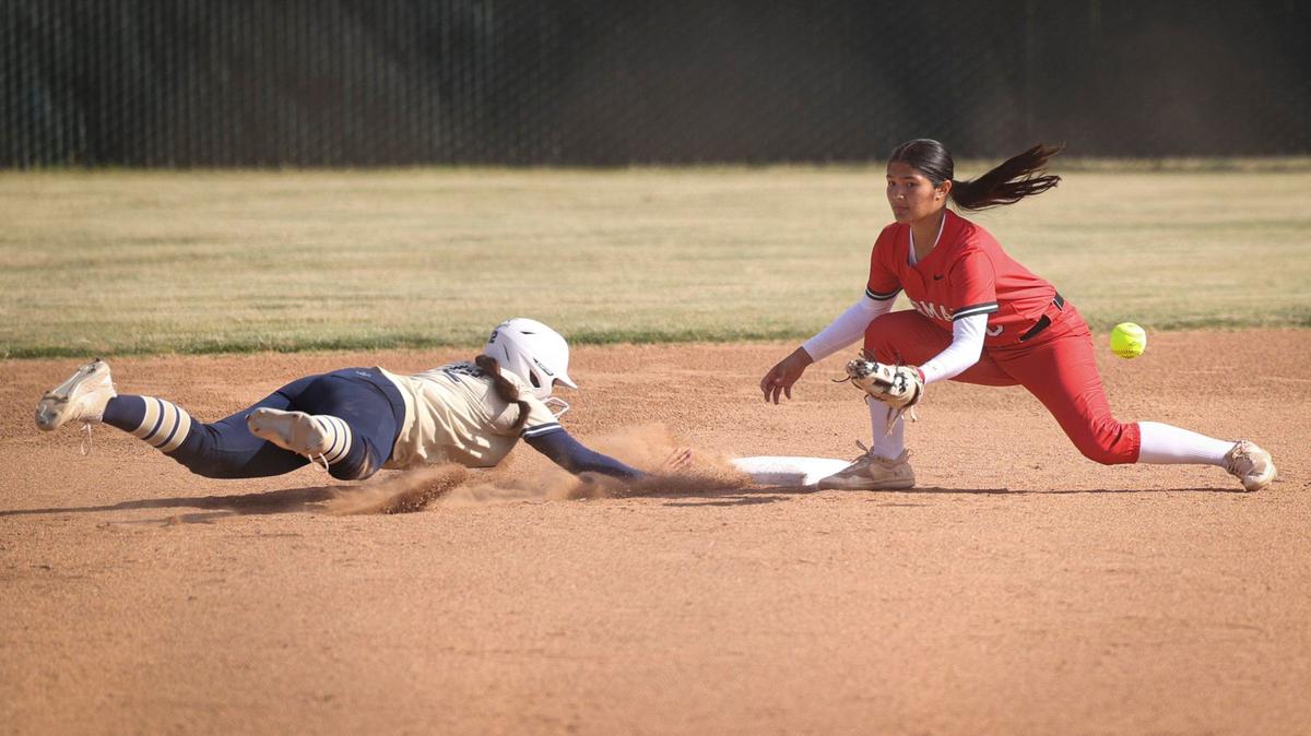 Sadie Huff dives back to second base as Sydney Yep fields. Mission Prep won 2-0 over Kerman in a softball playoff May 22, 2024.