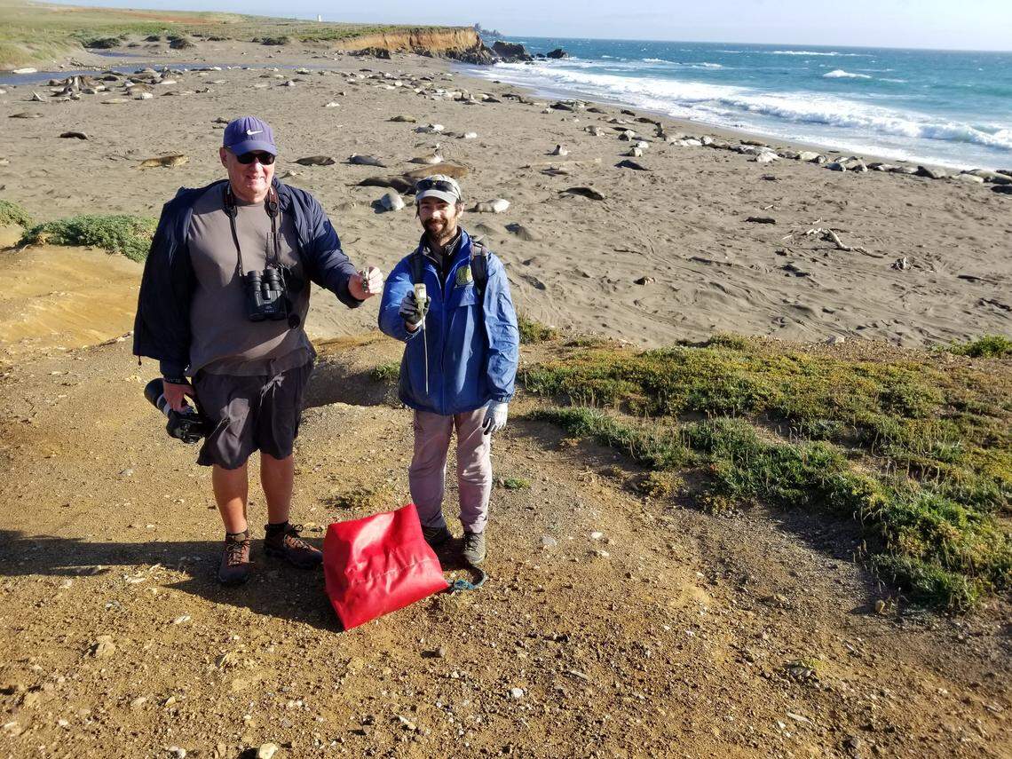 Phil Arnold, with his spotting scope, and Patrick Robinson, showing the retrieved device.
