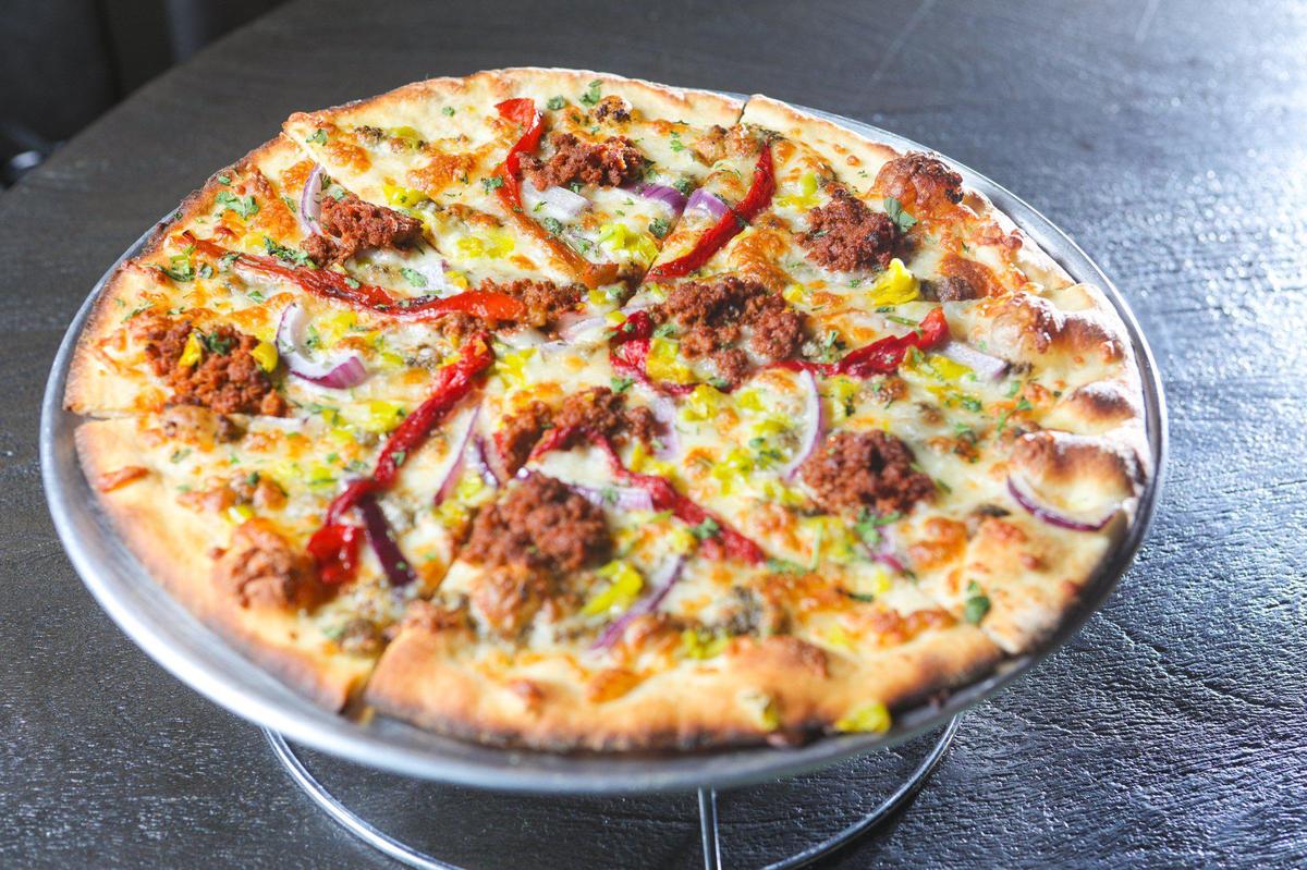 The Pesto Verde Pizza at Cielo Ristorante and Rooftop Bar includes chorizo, cilantro, pepperoncini, roasted peppers, red onion and house pesto.
