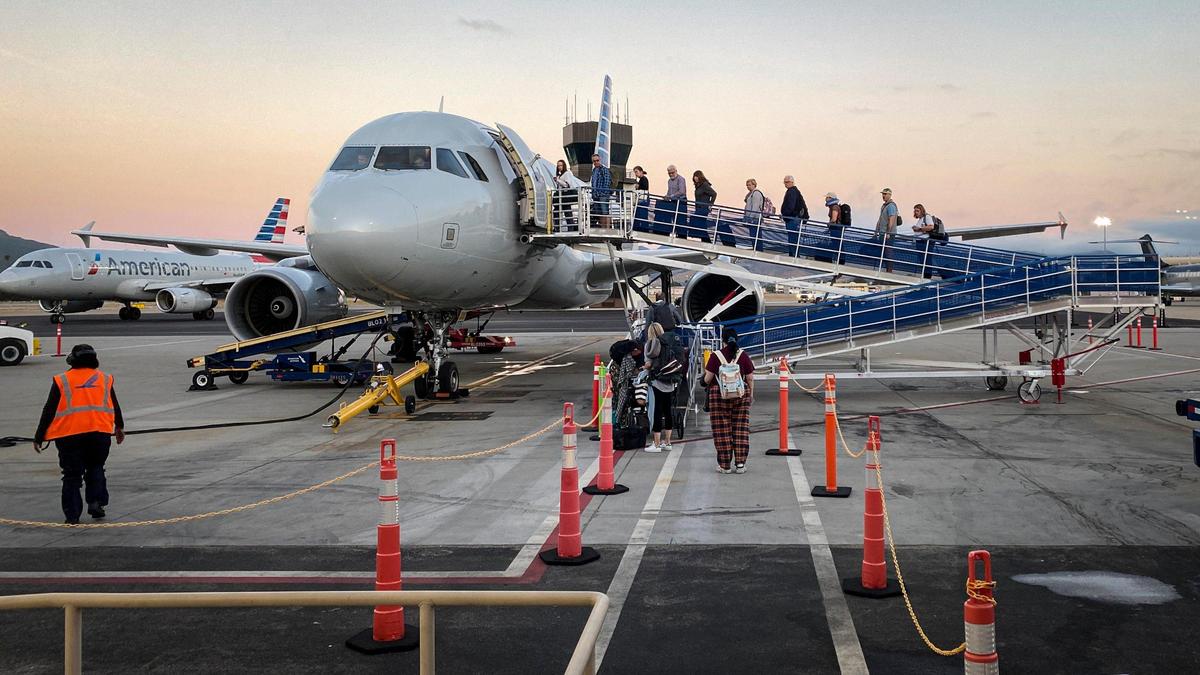 Departing passengers board an American Airlines flight for Phoenix at the San Luis Obispo County Regional Airport the morning of July 16, 2024.