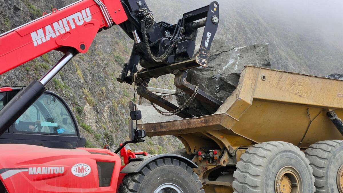 Large chunks of Franciscan melange stone mined from a quarry on Foothill Boulevard near the foot of Bishop Peak are unloaded at a Highway 1 construction site. The project will stabilize the roadway near Big Sur Lookout.