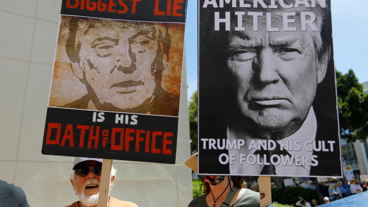 Signs at the June “No Kings” protest in front of the San Luis Obispo County courthouse.