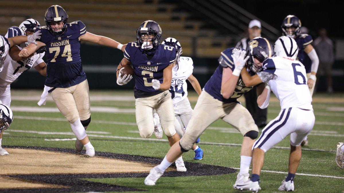 Mission Prep’s offensive line opens up running room for Chase Untal, who scored on this run with blocking help from Case Christiansen, left, and Gabe Rodriguez. MIssion Prep beat Aptos 18-15 in a home football game at Cal Poly’s Spanos Stadium on Sept. 8, 2023.