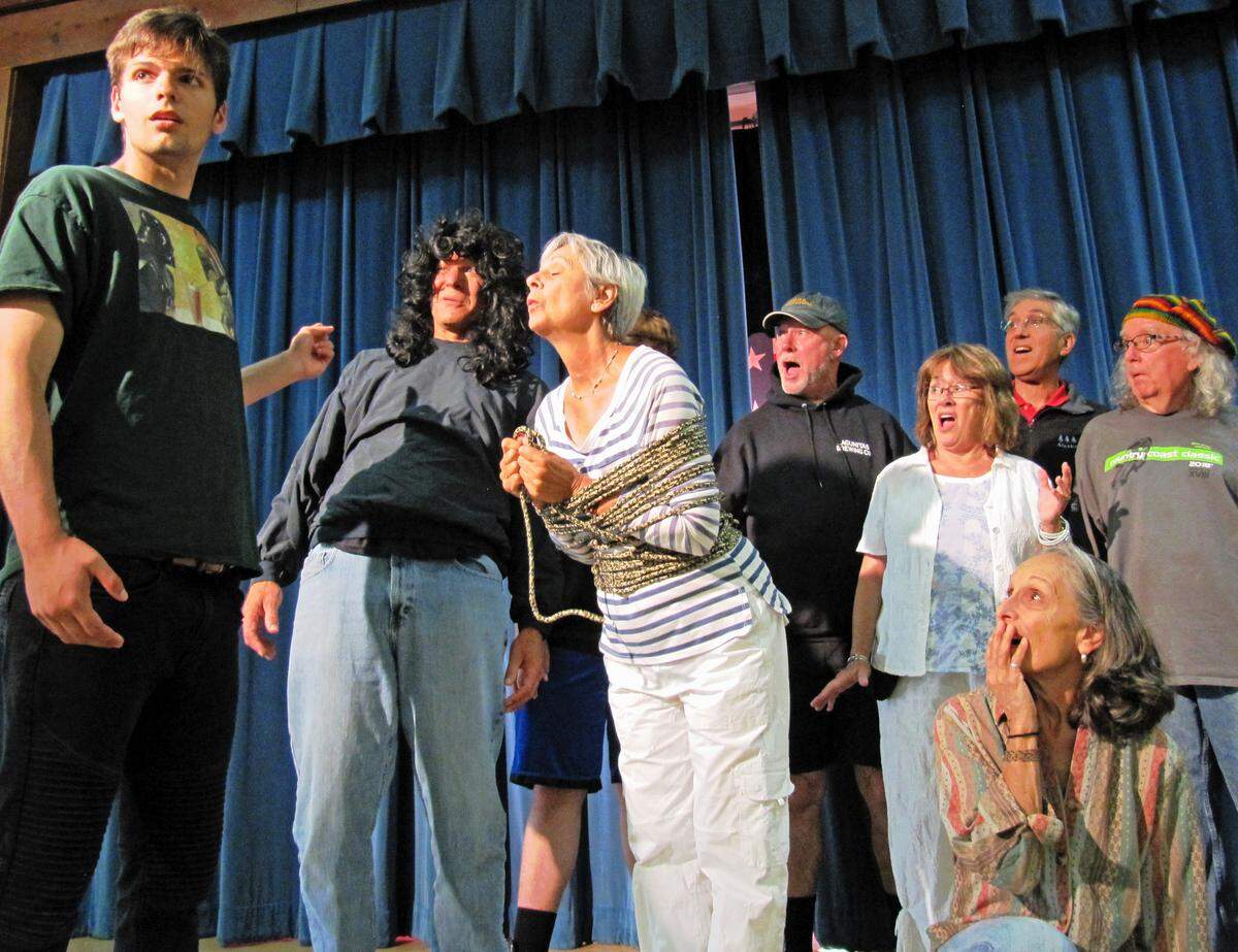From left, during an Aug. 7 rehearsal for the 2018 Pinedorado Follies show, Darien Jewel (who portrays Hero in show-in-a-show melodrama) reacts to the sudden reappearance of ‘Villain’, played by Kirk Henning, as the still-tied-up heroine Praline (MaryAnn Grau) waits for a kiss from the Hero who had saved her from the evil Villain. Meanwhile, some other members of the cast share Hero’s dismay at the latest twist and turn in the script. The show runs Aug. 29 through Sept. 2.