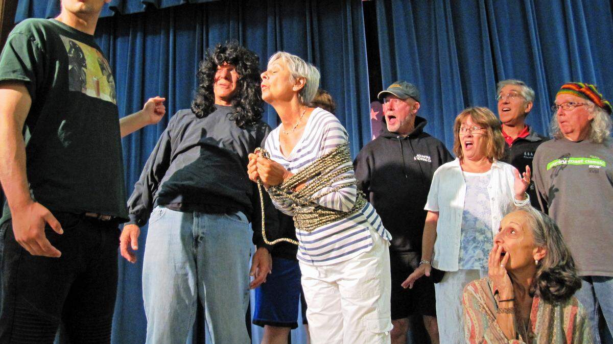 From left, during an Aug. 7 rehearsal for the 2018 Pinedorado Follies show, Darien Jewel (who portrays Hero in show-in-a-show melodrama) reacts to the sudden reappearance of ‘Villain’, played by Kirk Henning, as the still-tied-up heroine Praline (MaryAnn Grau) waits for a kiss from the Hero who had saved her from the evil Villain. Meanwhile, some other members of the cast share Hero’s dismay at the latest twist and turn in the script. The show runs Aug. 29 through Sept. 2.