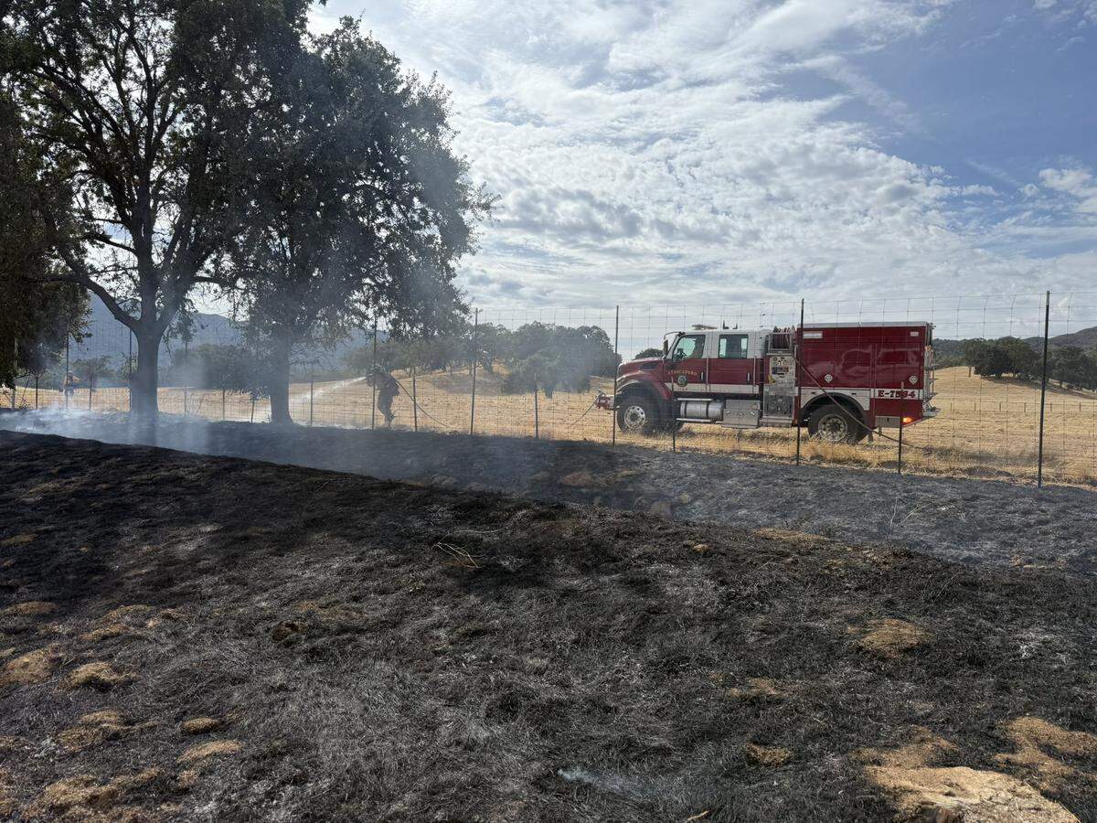 Cal Fire works to extinguish a blaze on Highway 101 near Santa Margarita on Wednesday, Sept. 17, 2025.