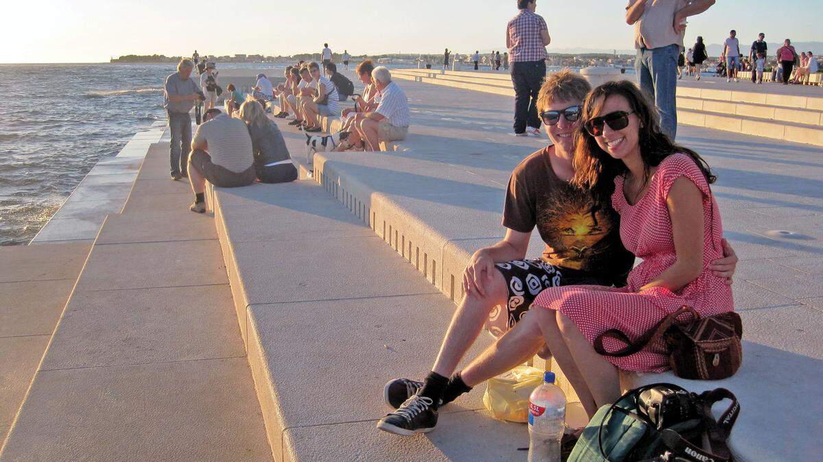 Jeff Nicklas and his girlfriend sit next to the Sea Organ in Zadar. Waves from the Adriatic Sea create music by pushing air through ‘wind pipes’ in the pier.
