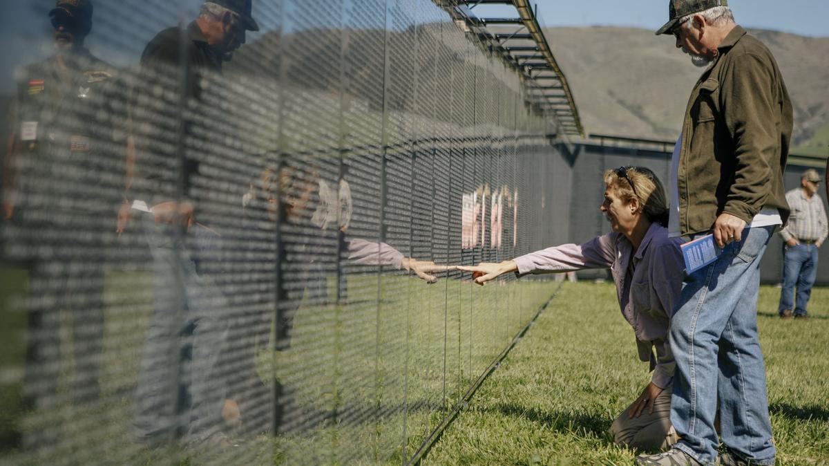 Gene Quayle and his wife, Cathy, of Grover Beach, find Gene’s friend’s name, Michael McDonald, on “The Wall That Heals,” a three-quarter-scale replica of the Vietnam Veterans Memorial Wall in Washington, D.C., on display at the Madonna Meadows.
