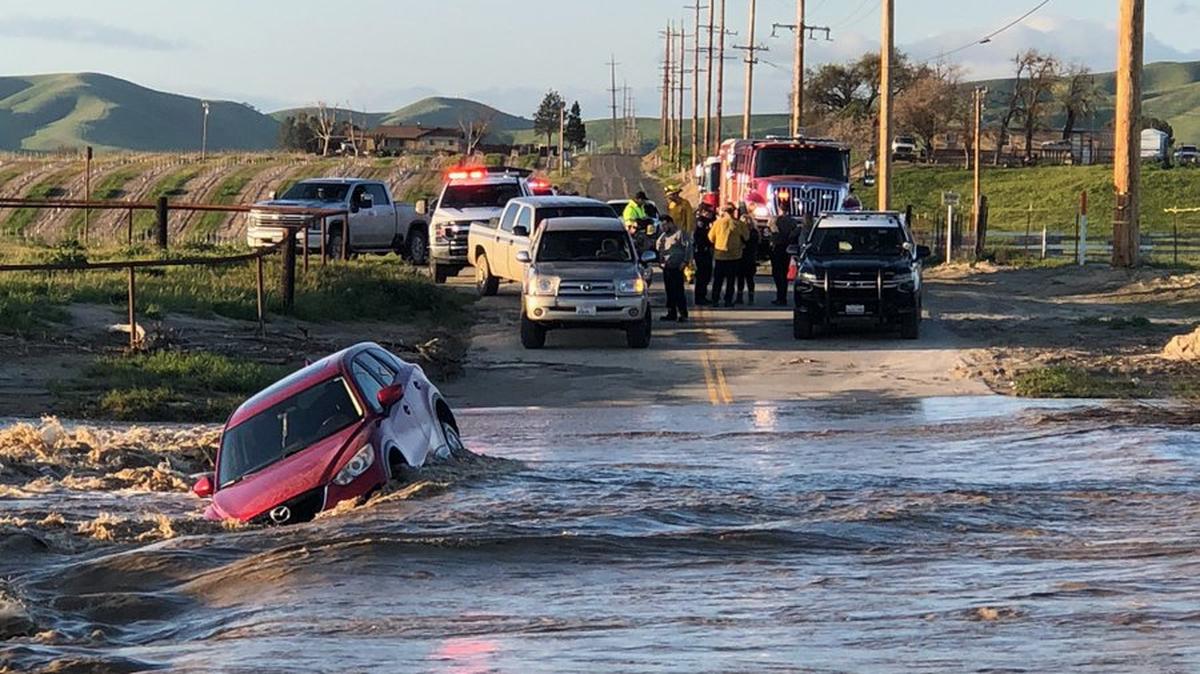 Firefighters respond to a vehicle stranded in the water on the north side of the Estrella River at the 8000 block of North River Road in Paso Robles on Thursday, March 23, 2023.