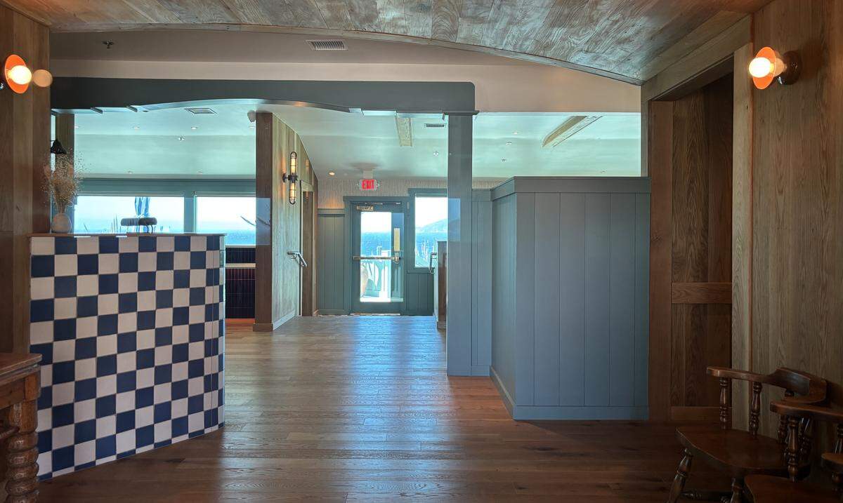 The interior of Westerly Shell Beach includes checkered decor, ocean blue painted fixtures and wood accents, seen here on April 8, 2026.