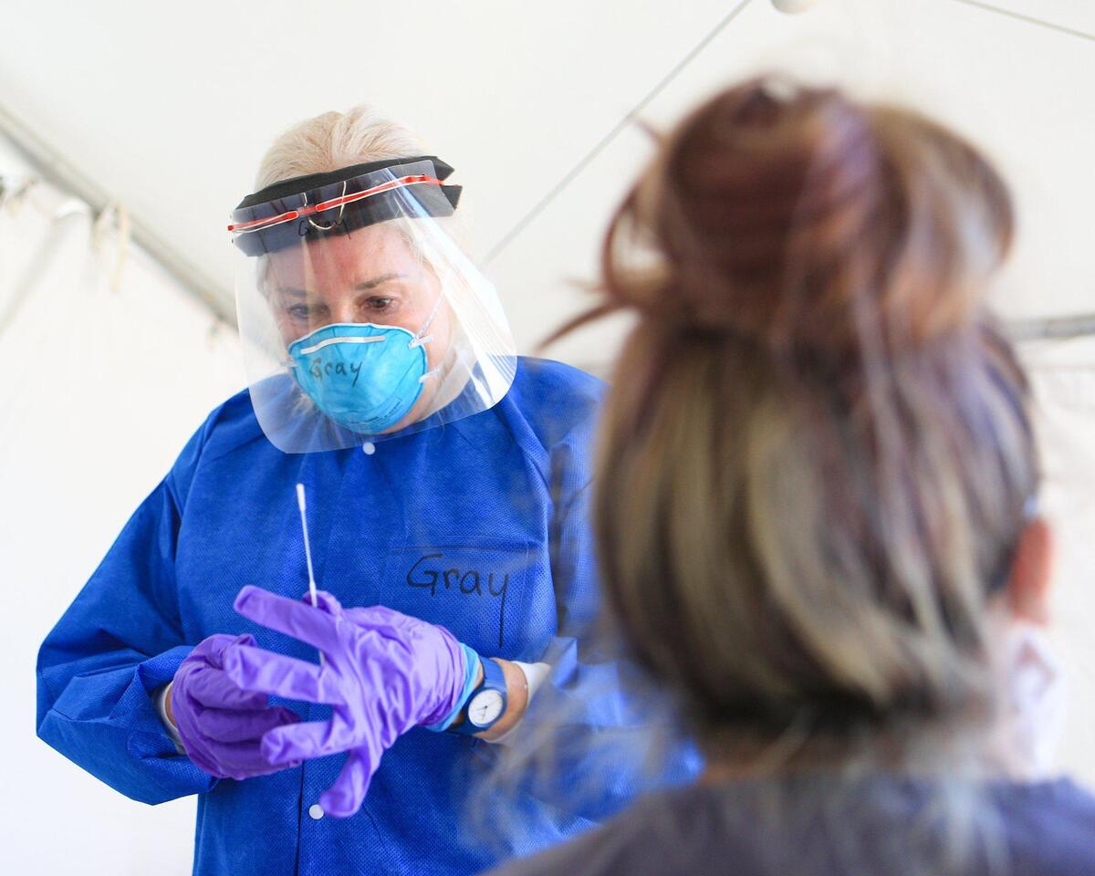 Public health nurse Karen Gray takes a coronavirus nasal swab sample at the San Luis Obispo County Public Health Department in May 2020.