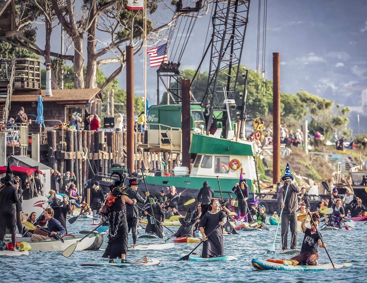 People dressed as witches and warlocks participate in the ninth annual Morro Bay Witches Paddle on Saturday, Oct. 22, 2022.