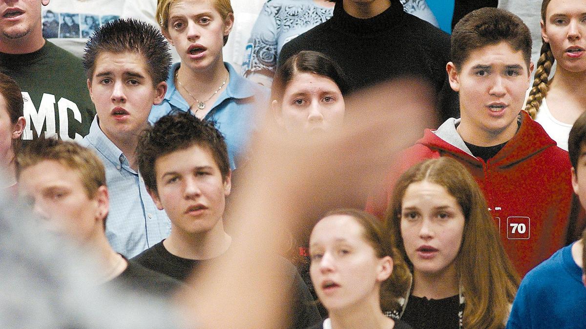 SLO County choir students sing at the hand of their director on Jan. 30, 2003.