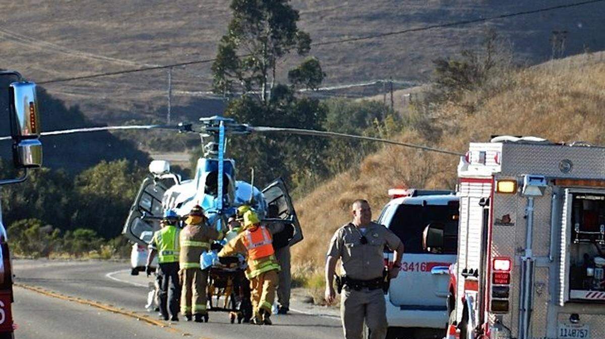 Emergency personnel take an injured person to a helicopter to be transported to the hospital after a rollover accident on Highway 1 north of Cayucos on Saturday afternoon.